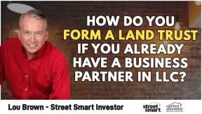 How do you form a land trust if you already have a business partner in LLC?